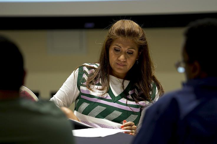 A woman studying papers at the 2nd Citizen Bond Committee meeting.