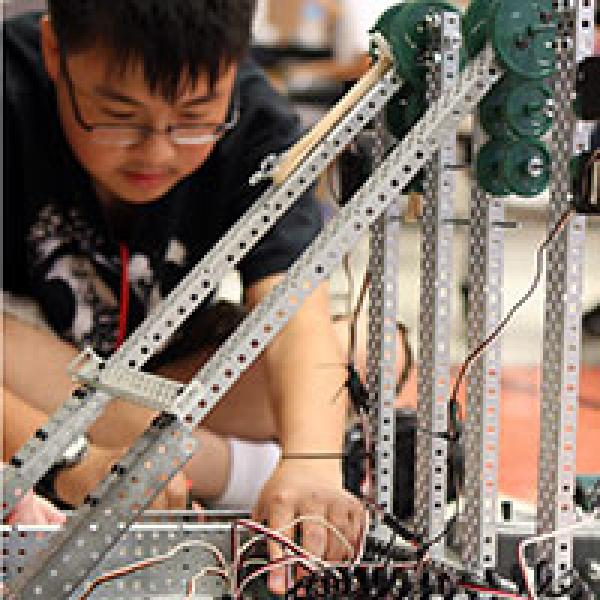 Boy in middle school MST program working on robotics
