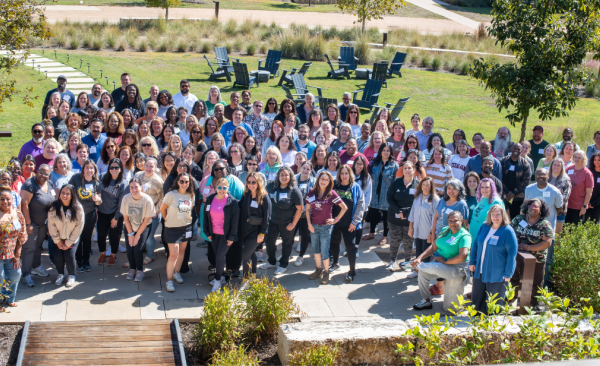 A large group of teachers standing together outdoors