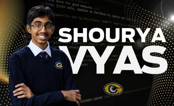 Shourya Vyas stands with arms folded and his name in big letters in the background